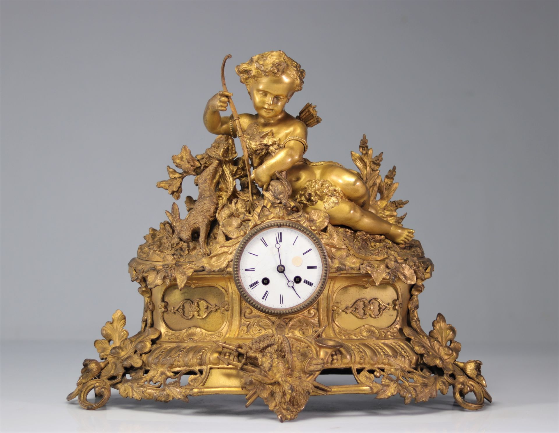 Louis XV clock in gilded bronze surmounted by a young arche