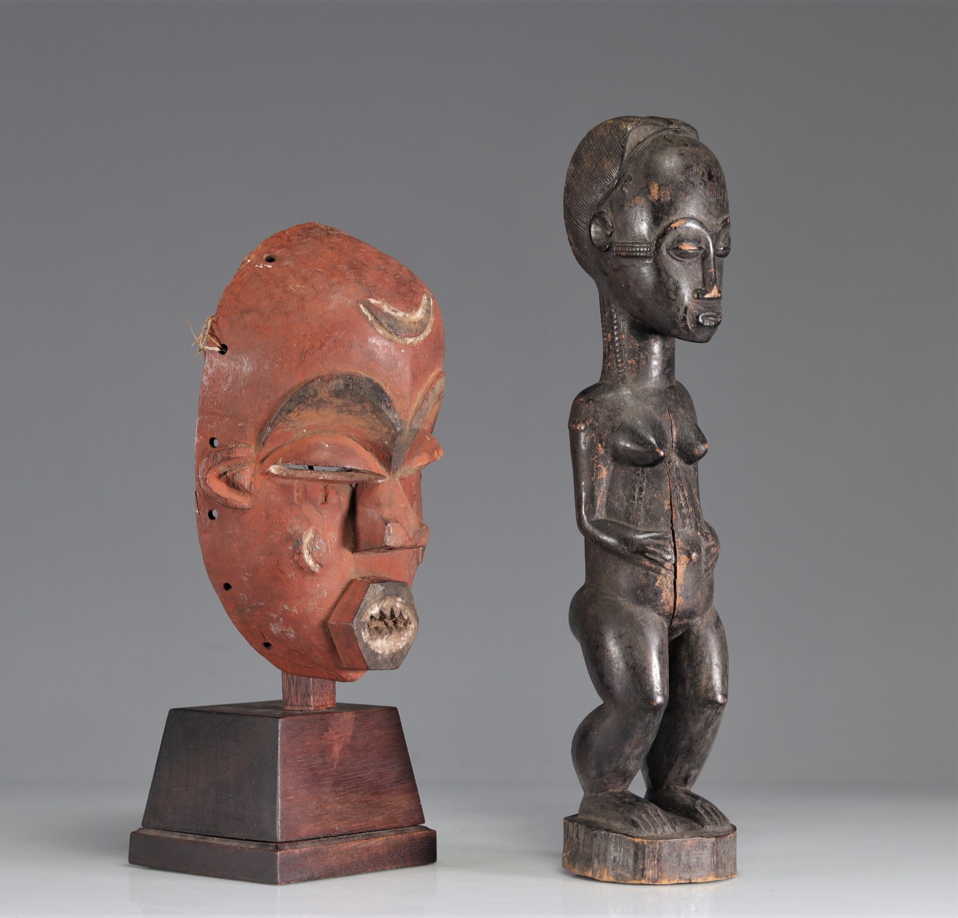 Baoule statue with dark patina joined with an African mask