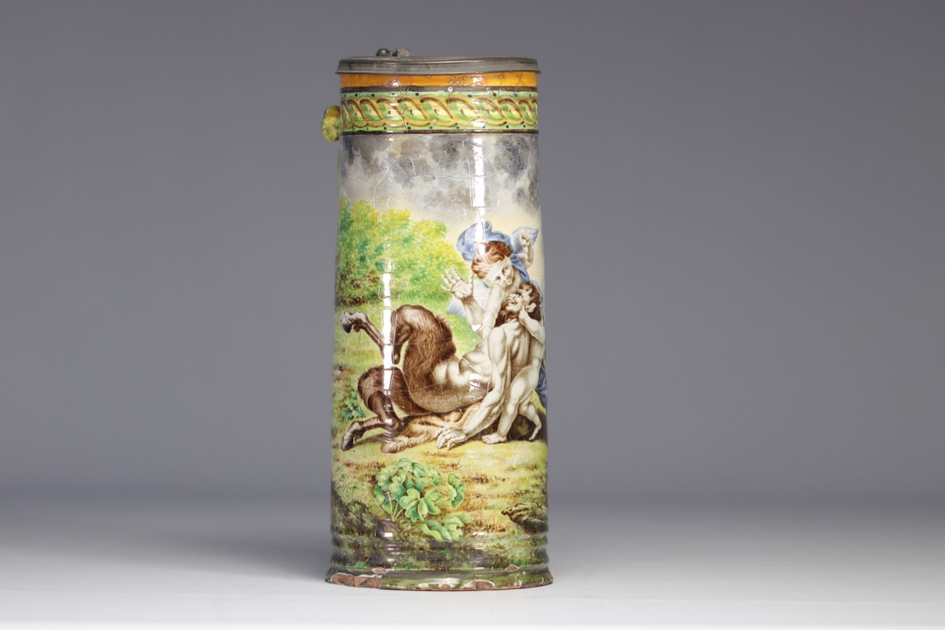 Italian majolica mug decorated with angels playing with a faun