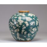 Chinese porcelain vase decorated en-relief on a green background