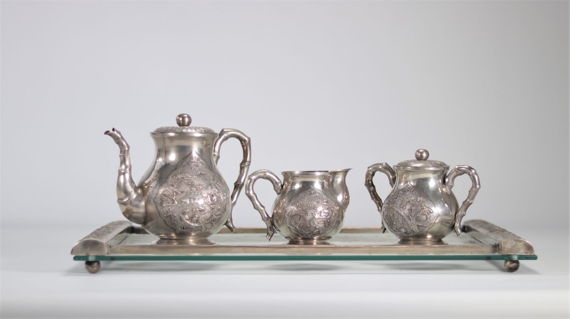 Chinese sterling silver service decorated with landscapes and handles decorated with bamboo probably