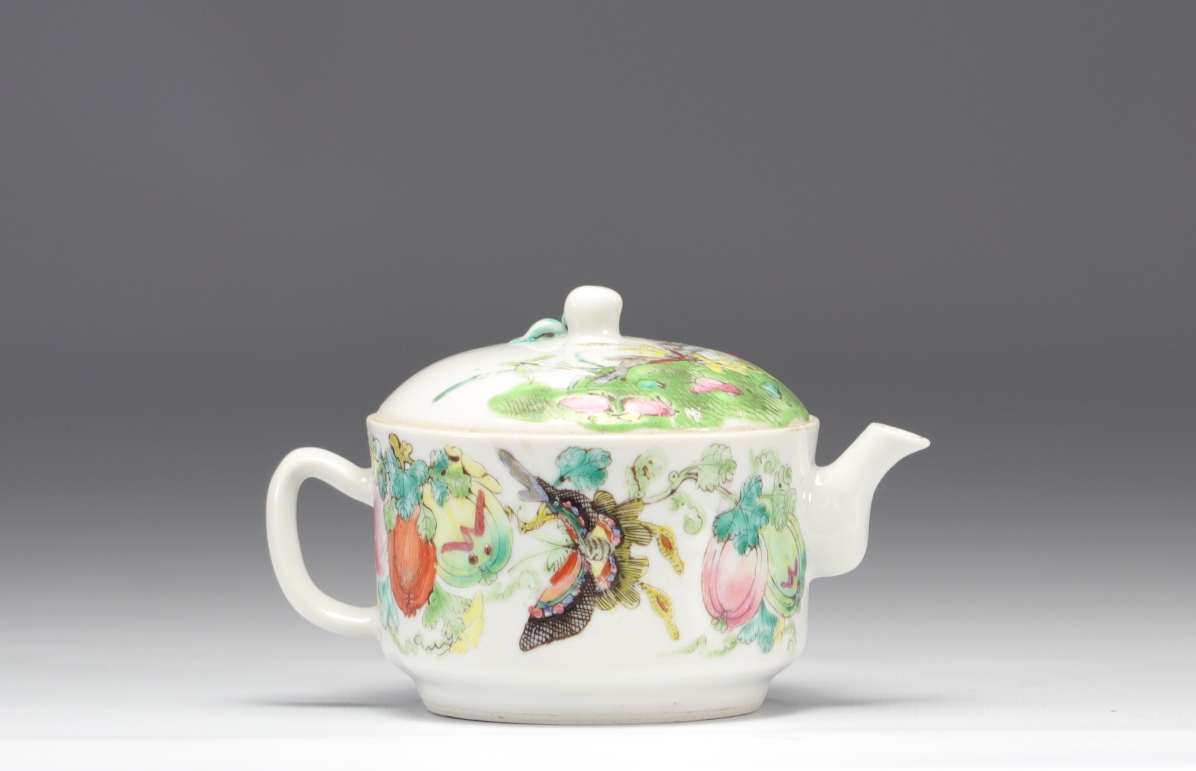 Famille rose porcelain teapot decorated with butterflies and flowers