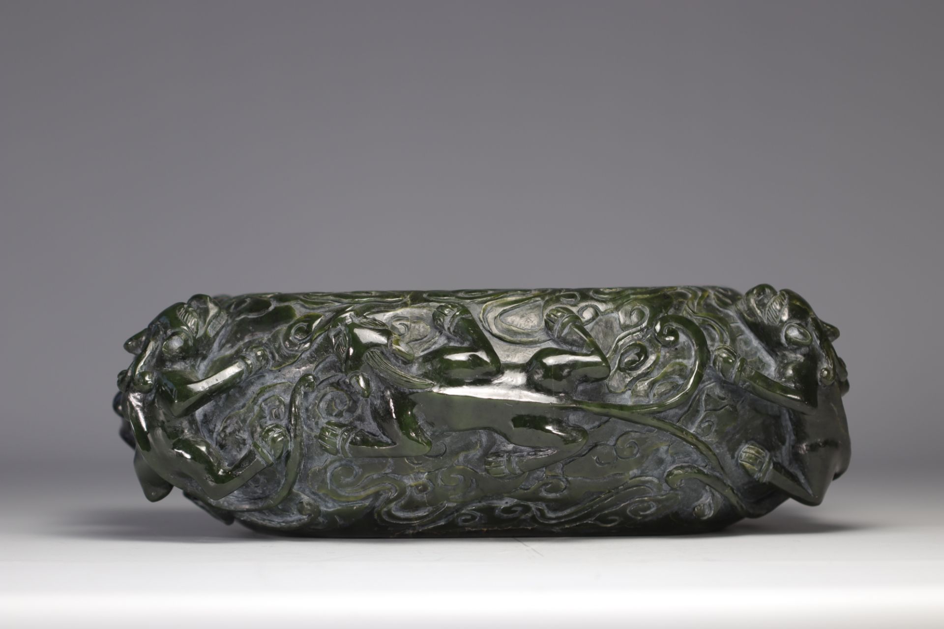 Impressive brushwork in spinach green jade decorated with Chilons