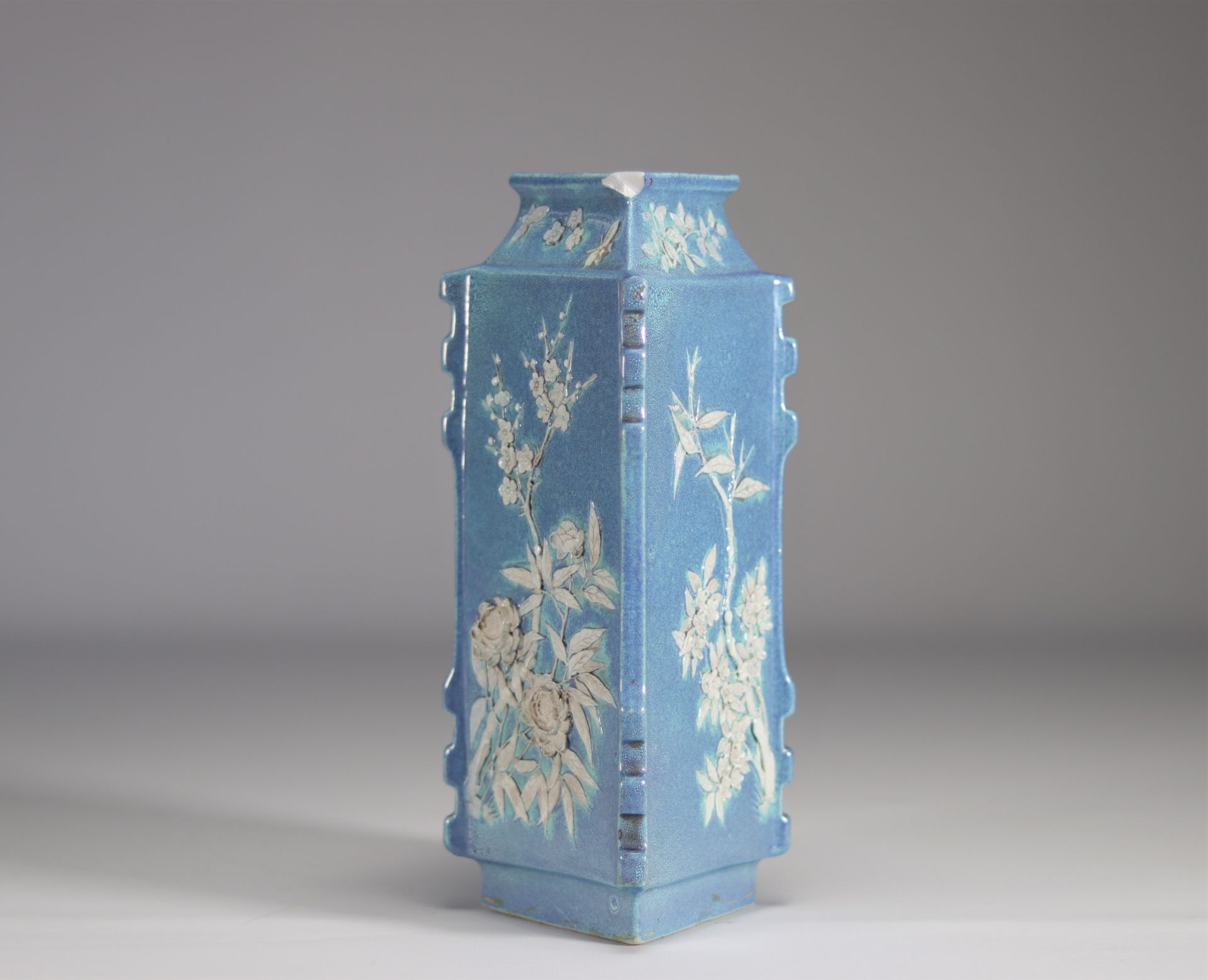 A Chinese porcelain vase decorated with flowers in relief on a light blue background from Qing perio - Image 2 of 5