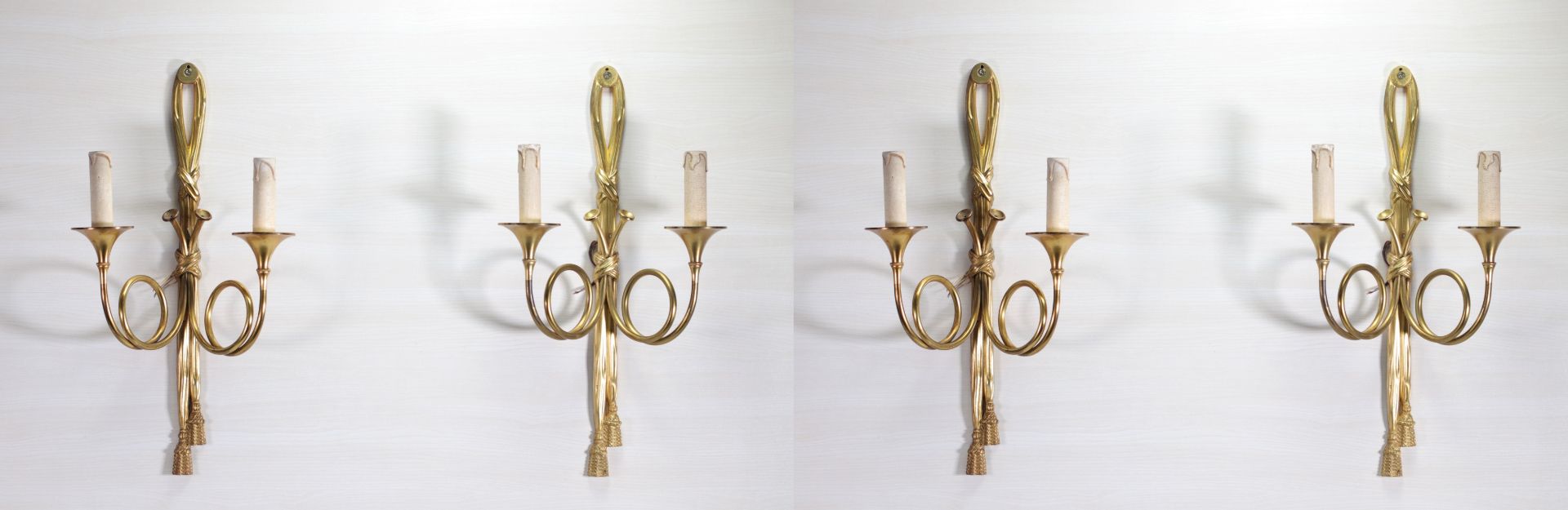 Series of four gilt bronze sconces forming knots