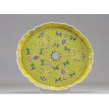 Chinese famille rose porcelain tray on a yellow background decorated with flowers