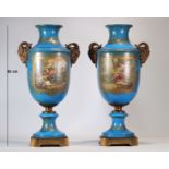 Pair of monumental Sevres porcelain vases decorated with bronze rams' heads and painted with romanti