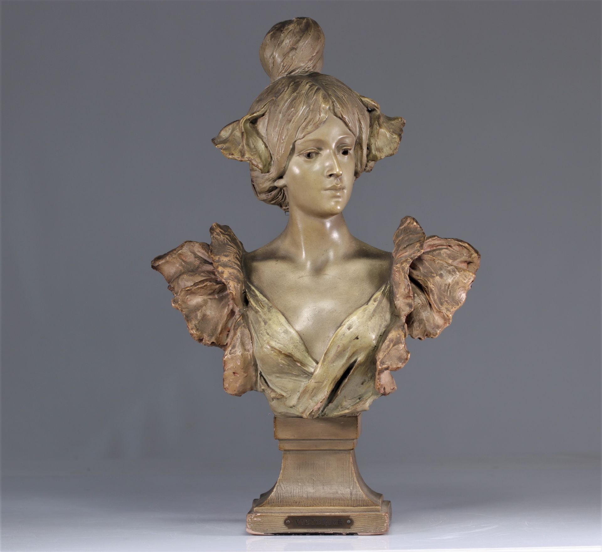 Art Nouveau bust of a young woman in patinated terracotta