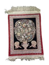 Rare silk prayer rug decorated with a flowering vase and two peacocks