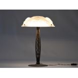 Art Deco desk lamp with hammered bronze base with 3 points of light and stylised glass hood signed "