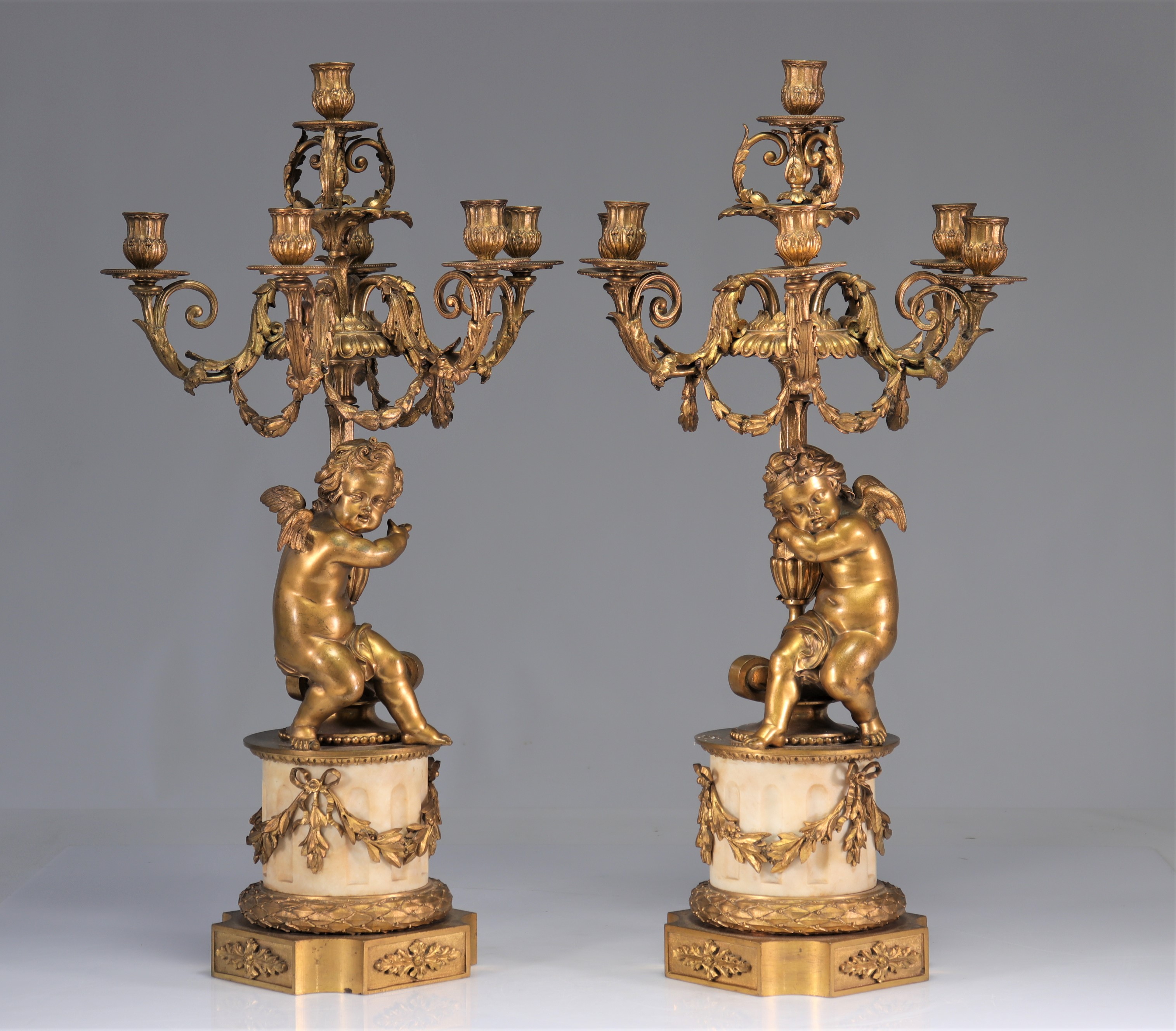 (2) Imposing pair of gilded bronze candelabra with marble base and "angels supporting the torches".