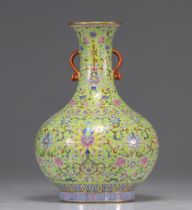A Famille Rose porcelain vase decorated with flowers on a yellow background from the Republic period