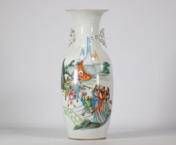 Famille rose porcelain vase decorated with figures and a landscape on a white background
