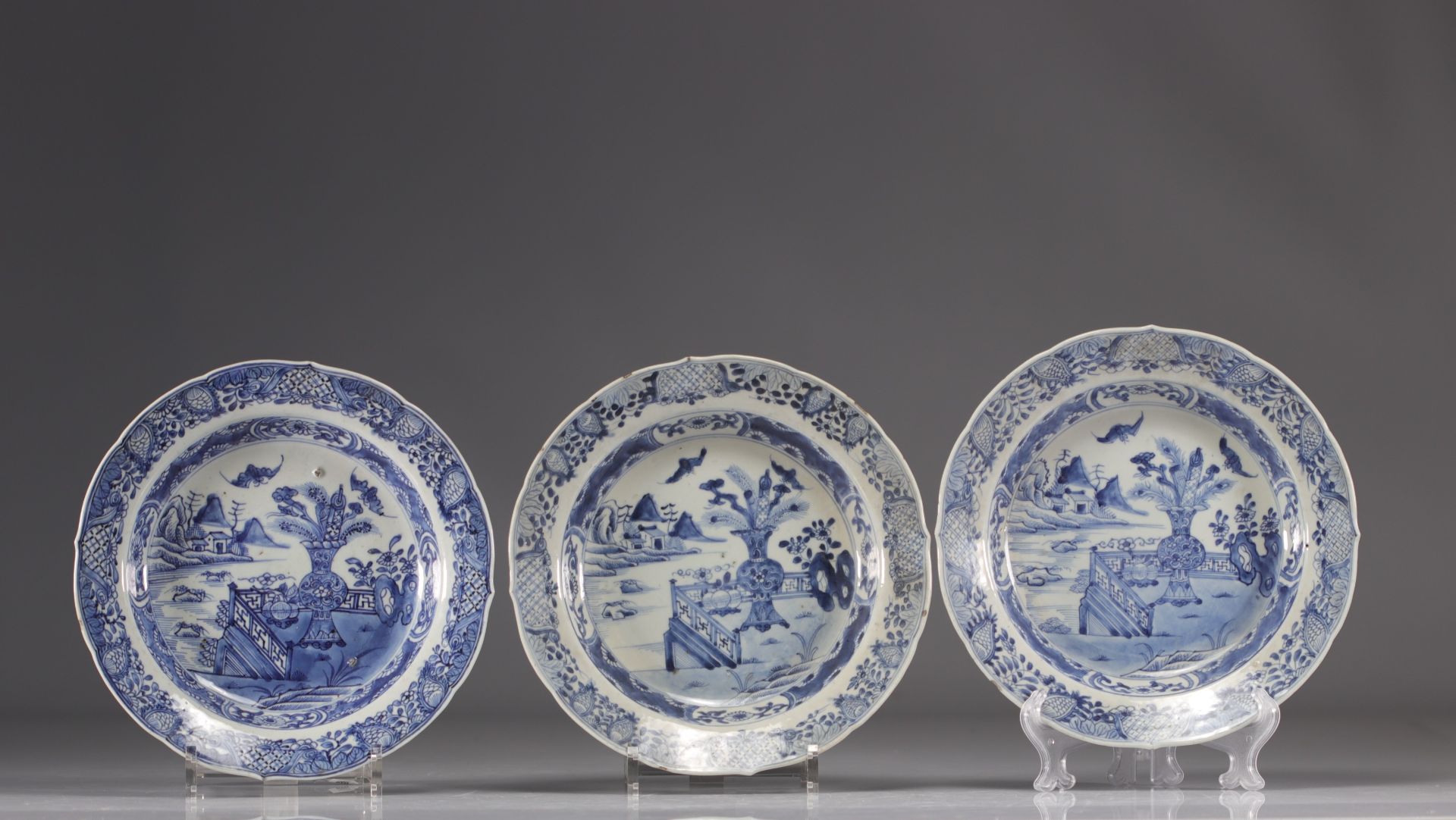 (3) Deep plates in white and blue porcelain decorated with flowering vases from China from the 18th