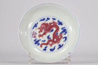 Blue and white dish with ruby enamel decorated with a dragon with Jing Wei Tang Zhi mark from 18th c