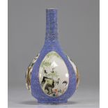 Chinese porcelain vase with cartouche painted scenes on a blue background