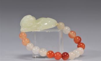Bracelet made of jade beads and stones with a lion carved in green jade