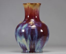 Porcelain vase covered with a red, blue and eggplant flamed glaze.