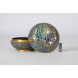 Round cloisonne box decorated with multicoloured flowers on a light blue background with the Qianlon