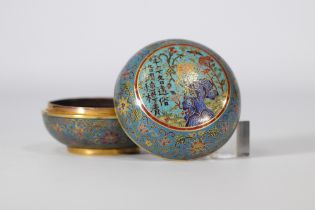 Round cloisonne box decorated with multicoloured flowers on a light blue background with the Qianlon