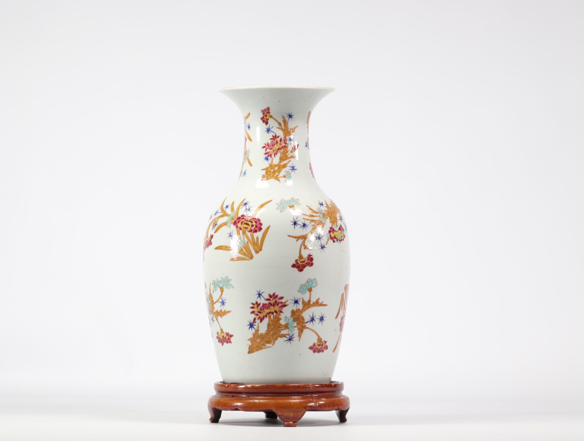 Famille rose porcelain vase with floral design on a white background