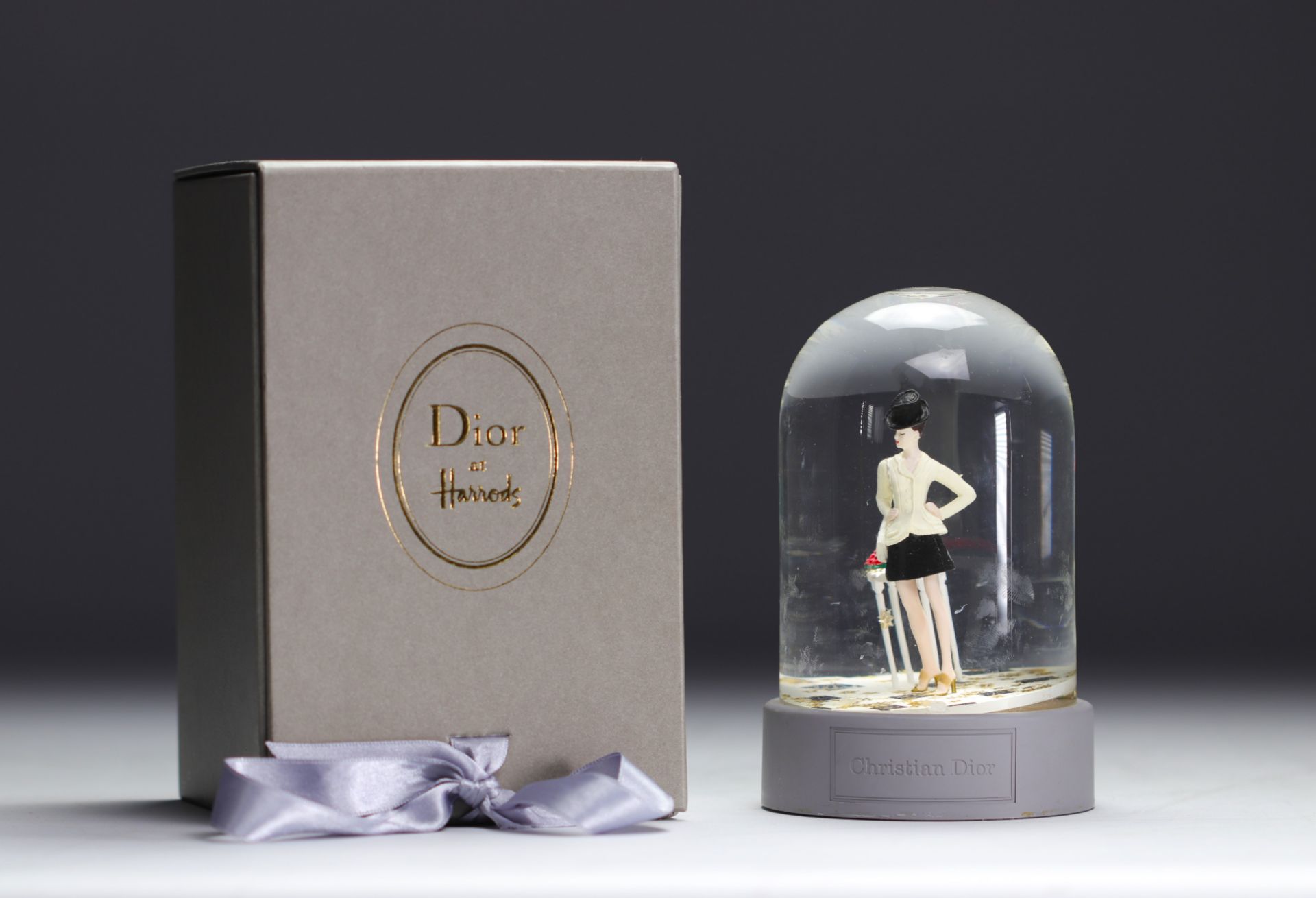 Christian Dior. 1997. Snow globe with golden star flakes featuring a customer from the Avenue Montai