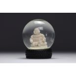 Michelin. 2007. Snow globe representing the Michelin Man in lotus position. Tire-shaped base. Number