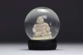 Michelin. 2007. Snow globe representing the Michelin Man in lotus position. Tire-shaped base. Number