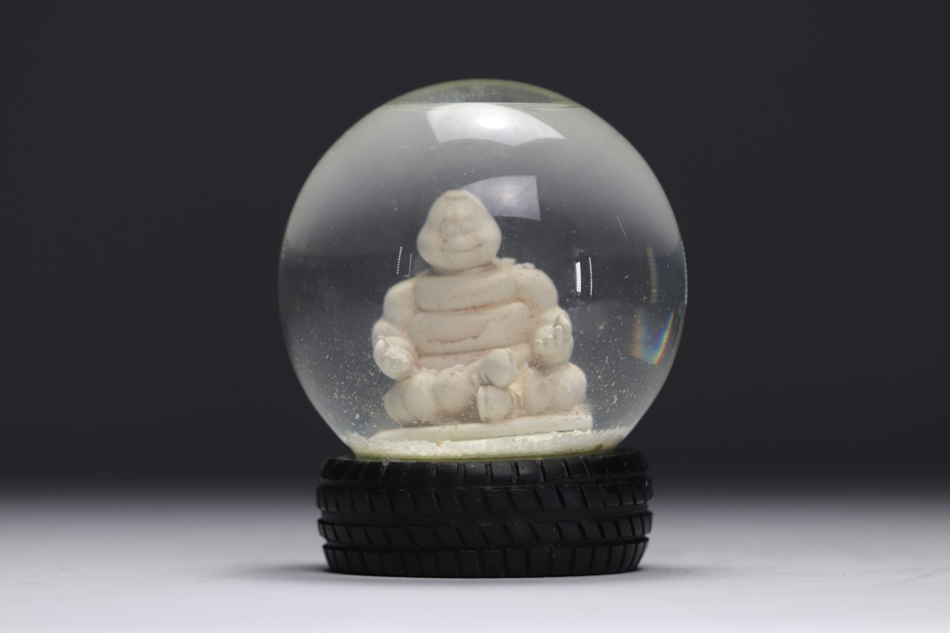 Michelin. 2007. Snow globe representing the Michelin Man in lotus position. Tire-shaped base. Number