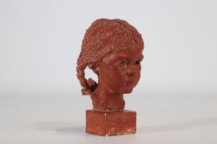 Red terracotta sculpture in the form of a young woman