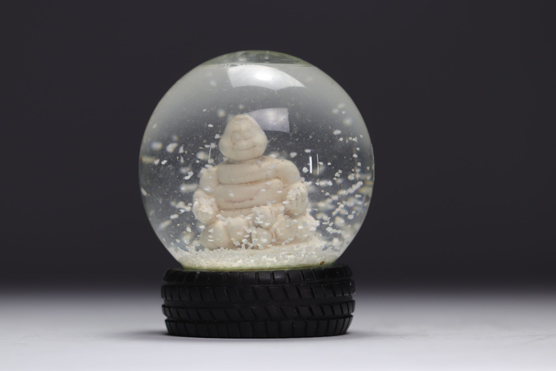 Michelin. 2007. Snow globe representing the Michelin Man in lotus position. Tire-shaped base. Number - Image 2 of 3