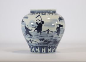 A white and blue porcelain vase with a landscape design