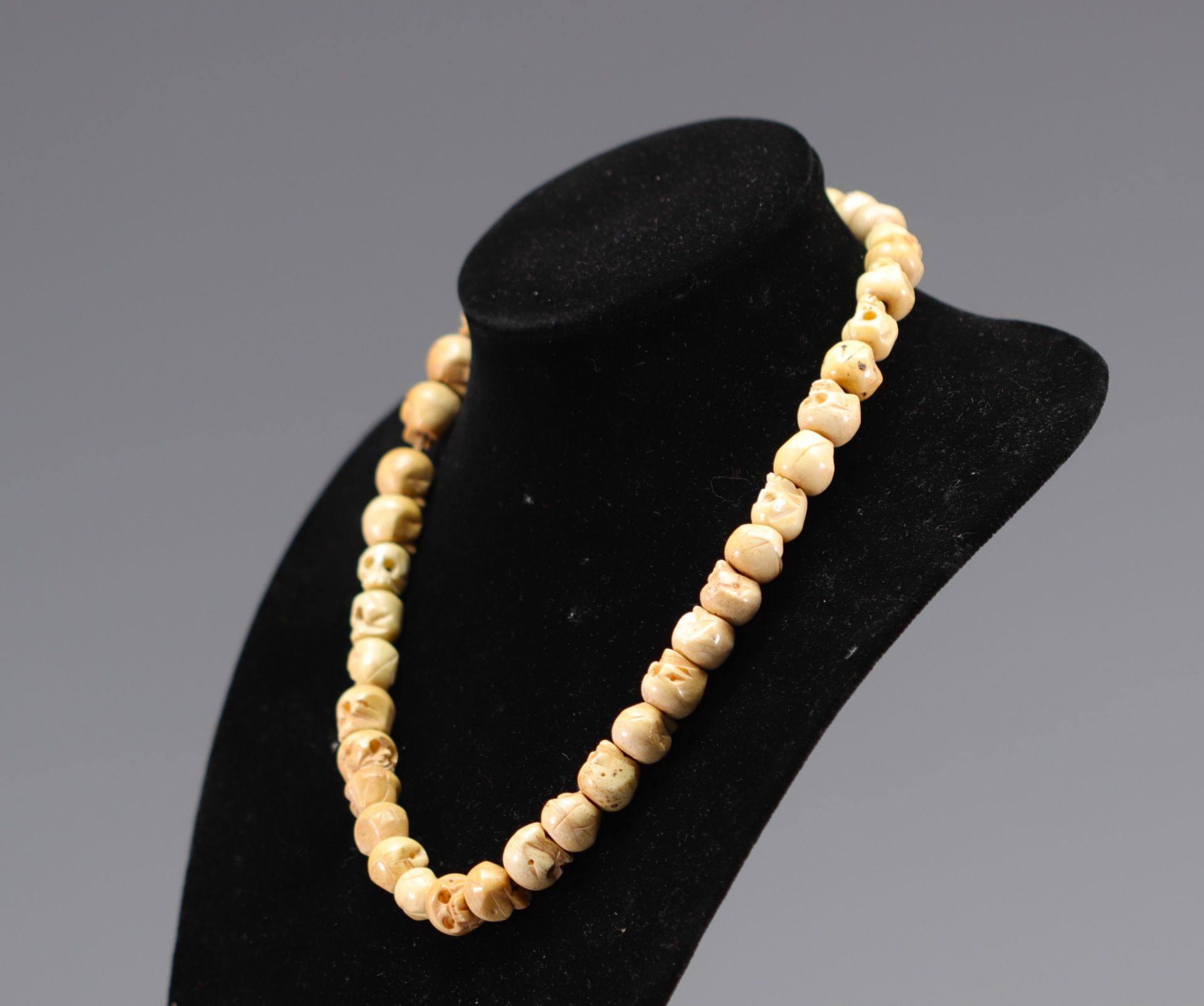 Necklace in bone carved with skulls