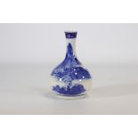 White and blue porcelain vase decorated with a landscape