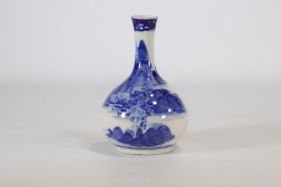 White and blue porcelain vase decorated with a landscape