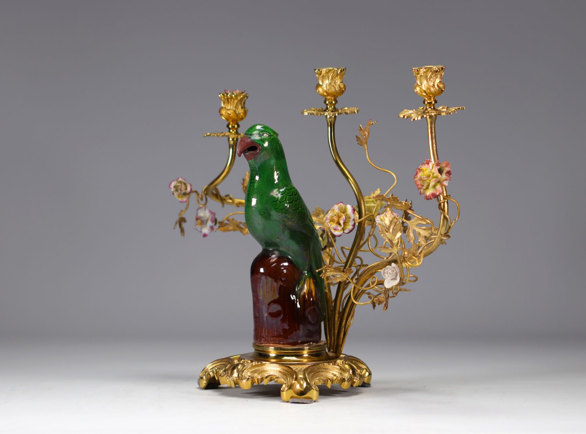 Chinese porcelain and gilt bronze candlestick decorated with a parrot and flowers 19th C