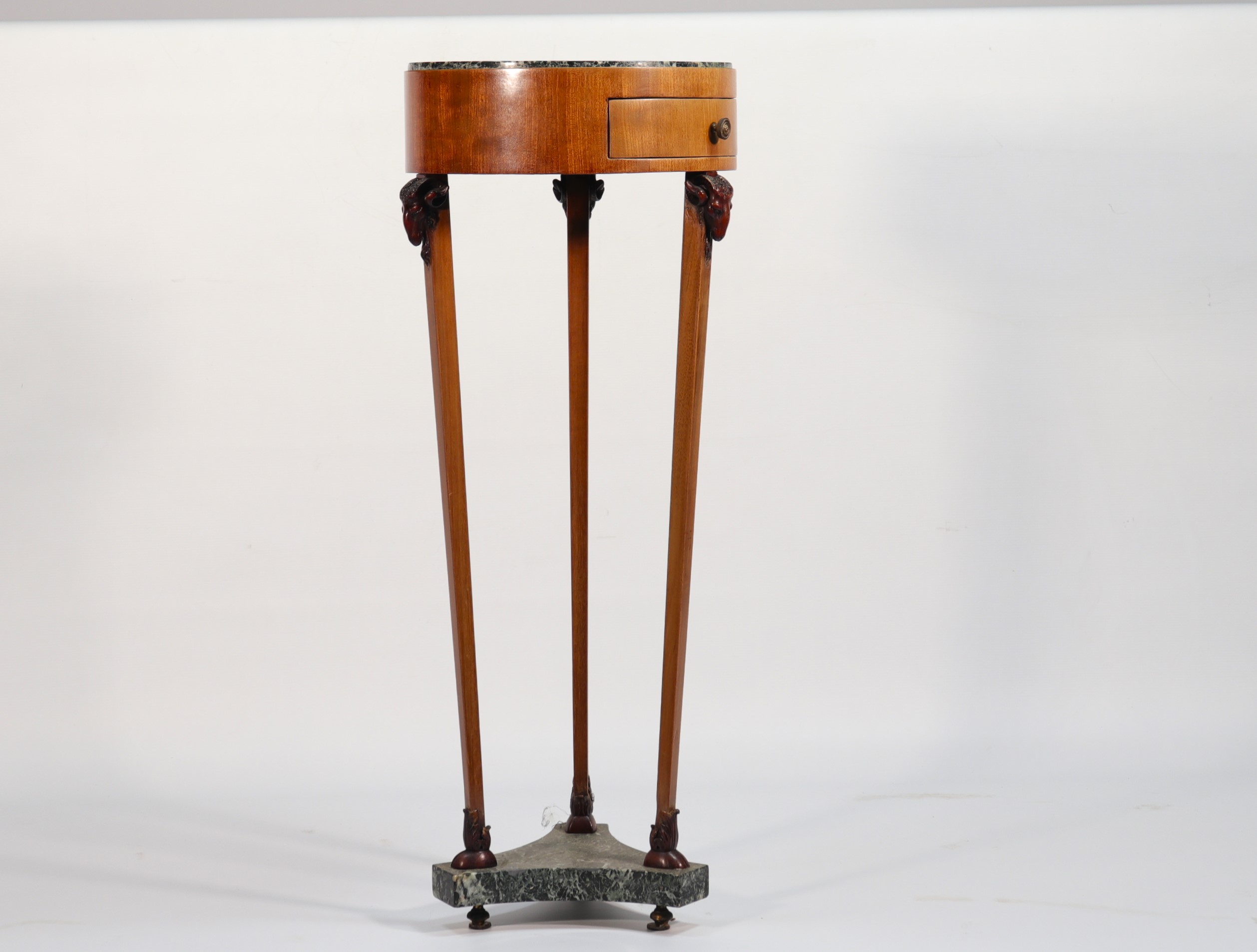 Empire period mahogany pedestal table, legs surmounted by carved ram heads.