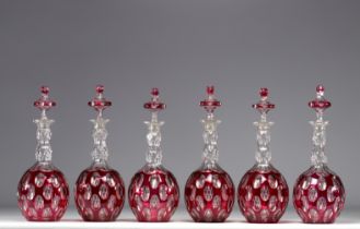 Set of six Baccarat crystal decanters in red and white lined glass, 19th century.