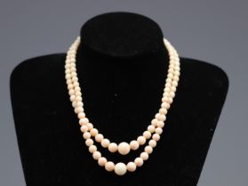 Two-row pink coral necklace, 18k gold clasp.