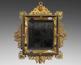 Mirror with pediments adorned with rocaille cherubs decorated with bronze and stones. Italian work.