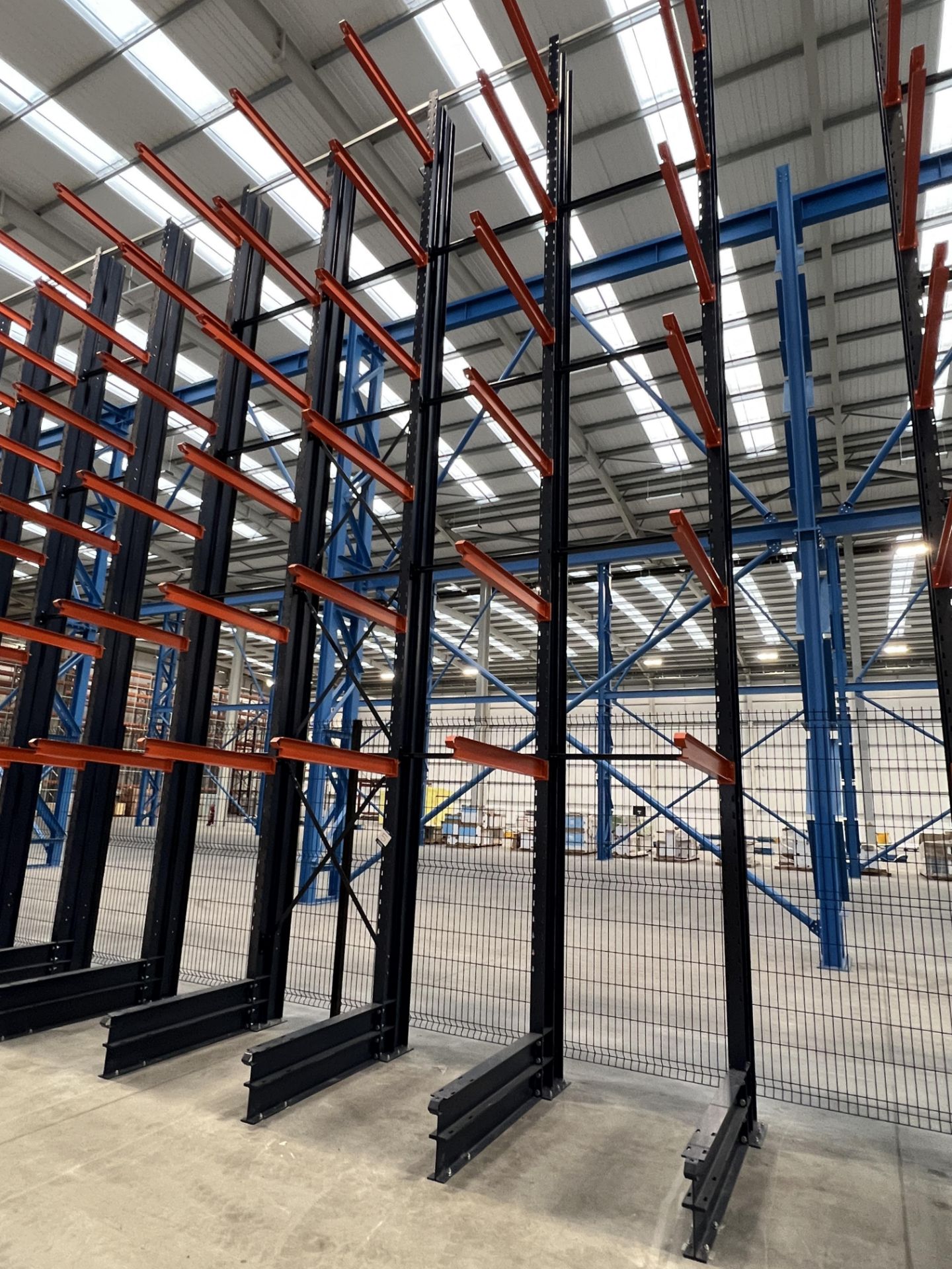 A Mecalux UK Shelving 8.8 m high block of cantilever racking (2021) with five column uprights,