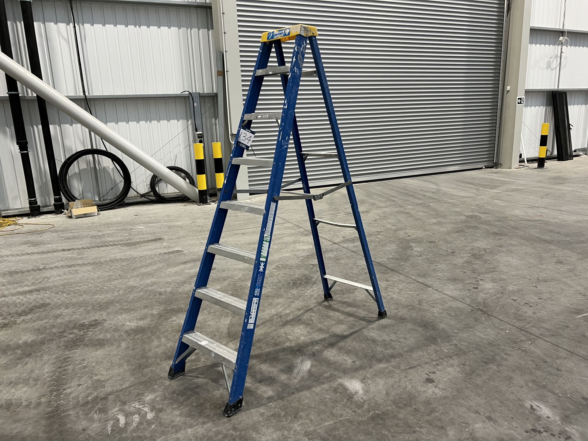 Clow Group fibreglass single 2.17m high 3 tread step ladder, maximum capacity 150 Kg.