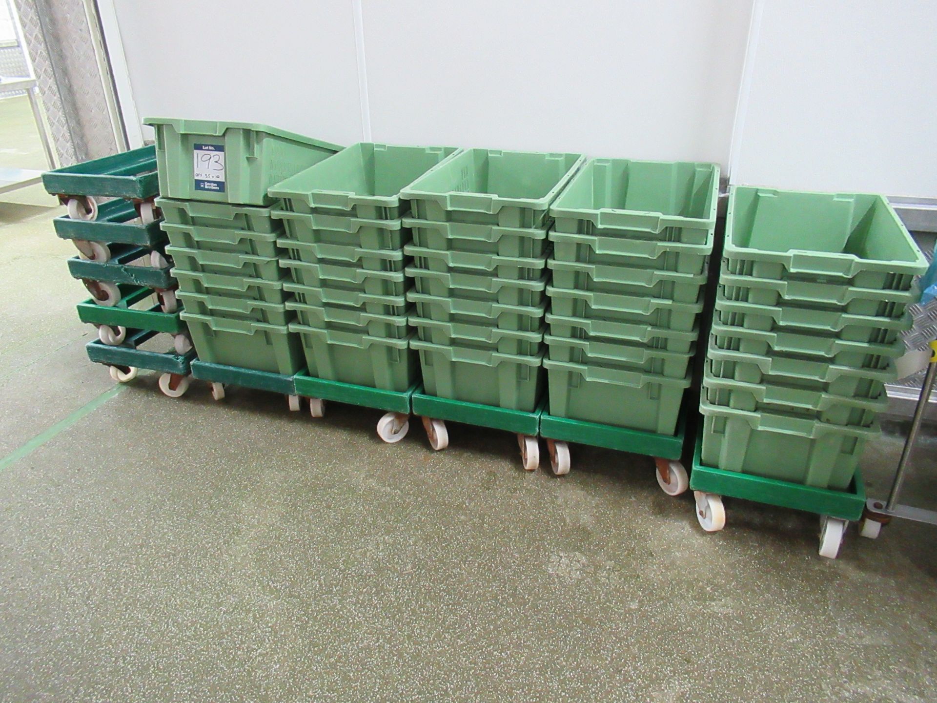 35 Green plastic stacking boxes with 10 dollies
