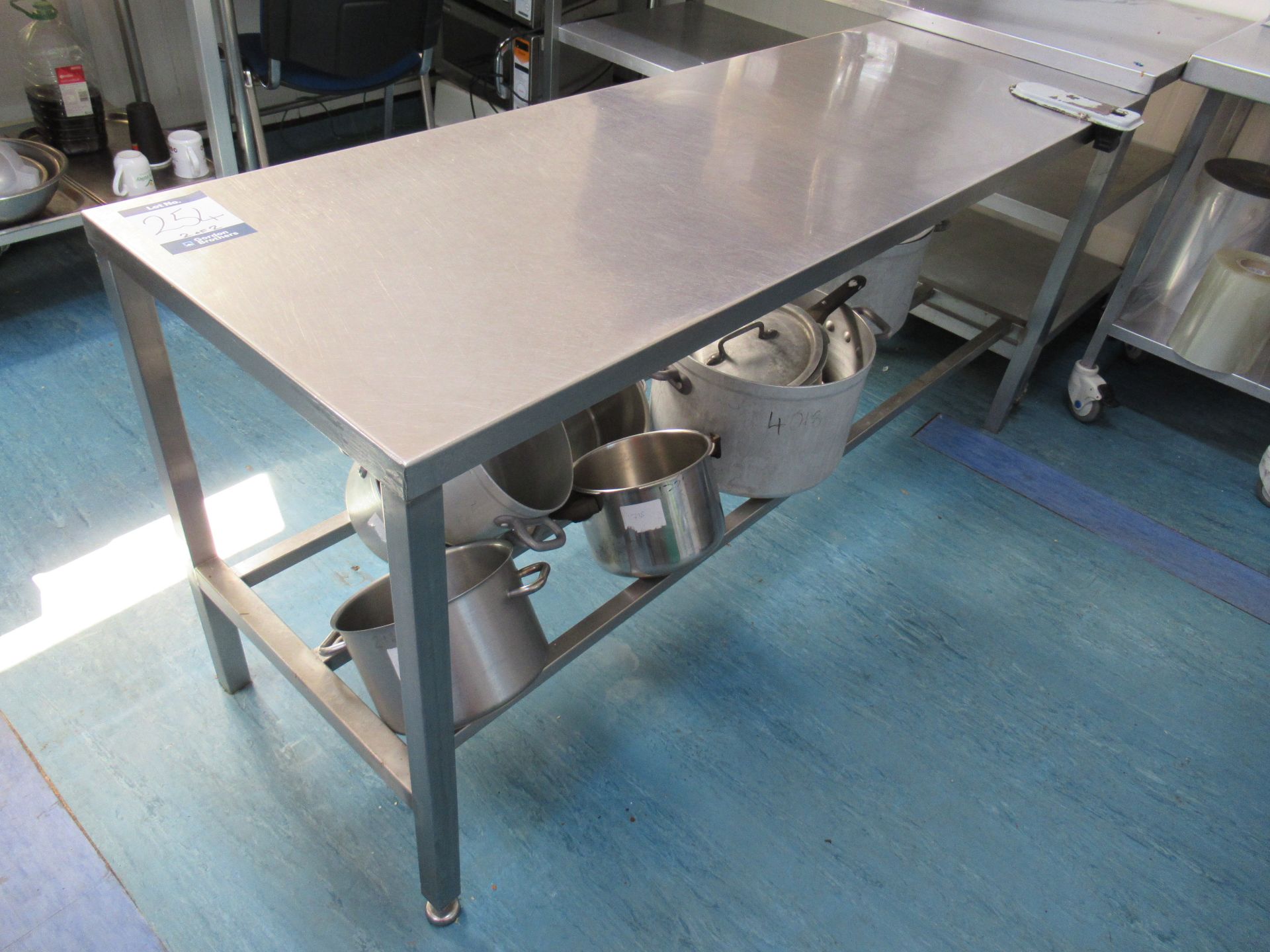 2 Stainless steel tables with 1800 x 600mm work surfaces, one with aluminium frame