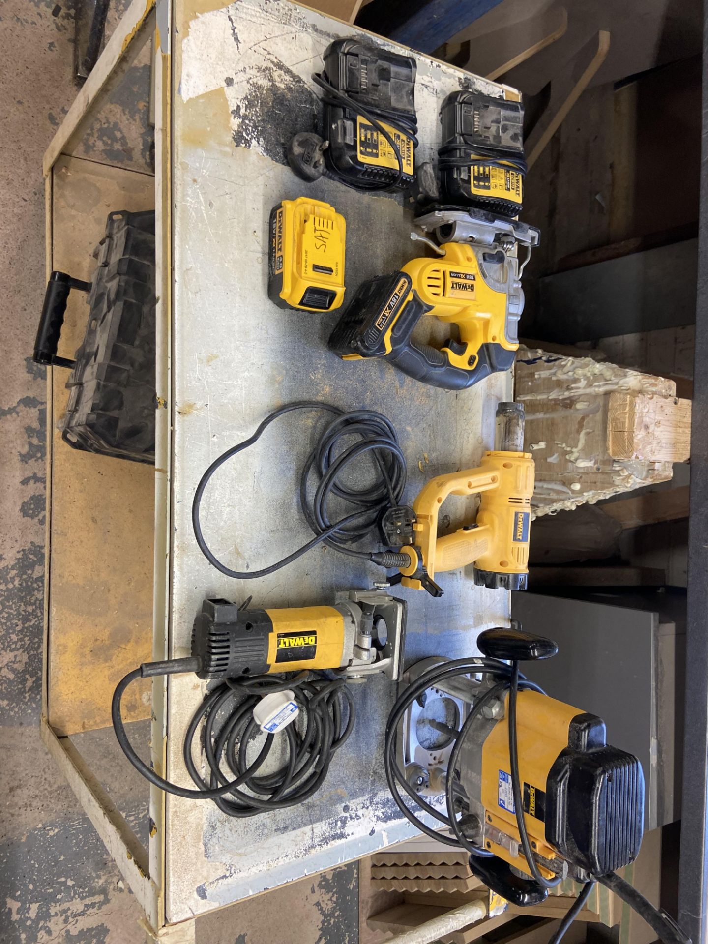 Quantity of DeWalt tools including, Cordless jigsaw DCS331, Plunge router DW624, Laminate trimmer