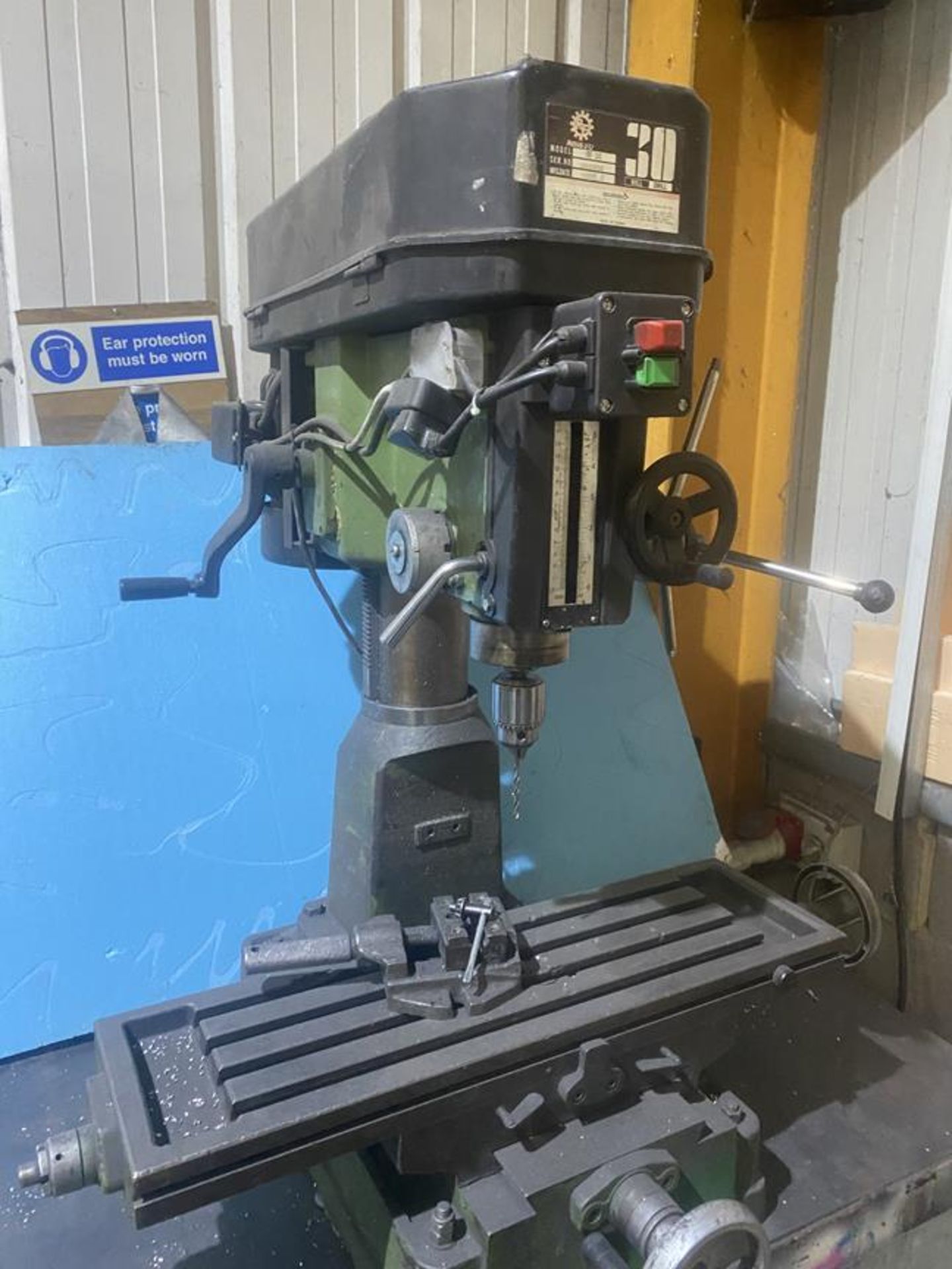 Kong bench top milling machine model RF30 mounted to steel workbench, serial No 982550 with 4"
