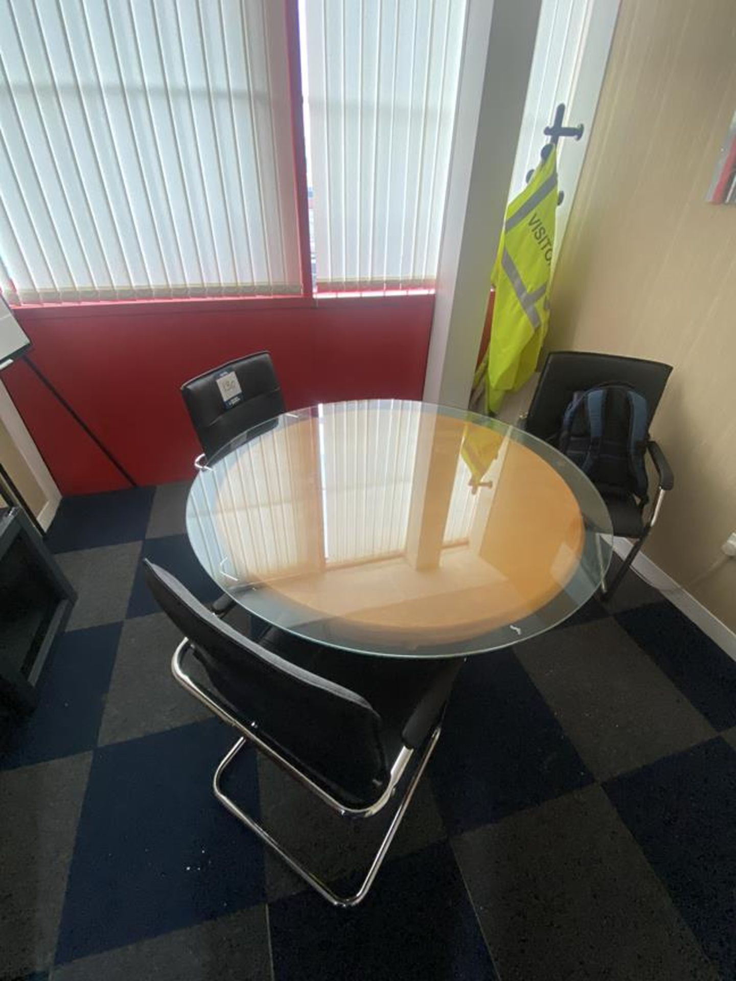 Glass topped 1200mm dia meeting table and 4 faux leather chairs