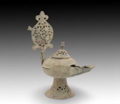 An Islamic Bronze Oil Lamp from the 12th Century with Beautiful Open Work on the Base, Lid and Handl