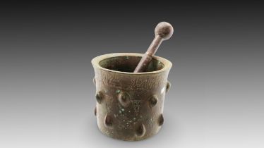 An Islamic Bronze Pestle and Mortar from the 12th Century Diameter of Mortar: Approximately 14.7cm