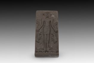 A Roman-Egyptian Telematic Plaque Cippus Standing Figure of Bes on Two Crocodiles Holding on the Lef